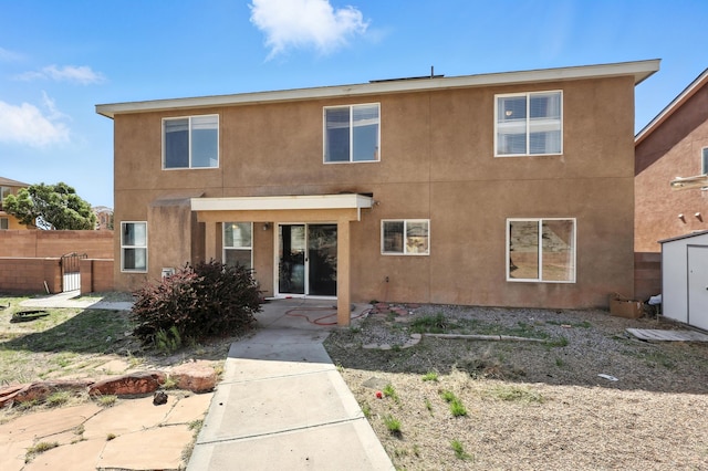 1230 Carrizo St NW, Los Lunas, NM 87031 - rear view of house featuring stucco siding