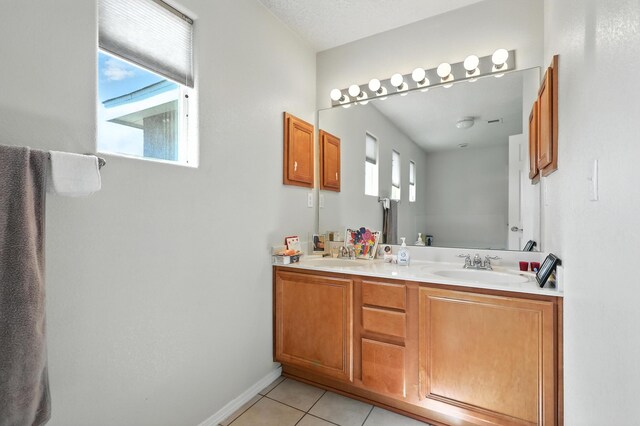 1230 Carrizo St NW, Los Lunas, NM 87031 - bathroom with plenty of natural light, tile patterned flooring, and double vanity