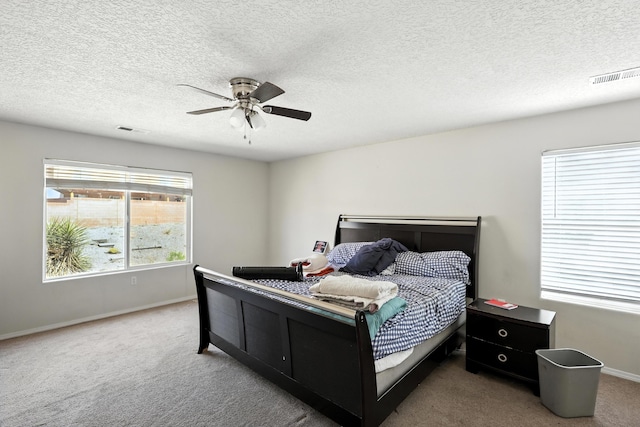 1230 Carrizo St NW, Los Lunas, NM 87031 - bedroom with carpet, ceiling fan, and a textured ceiling