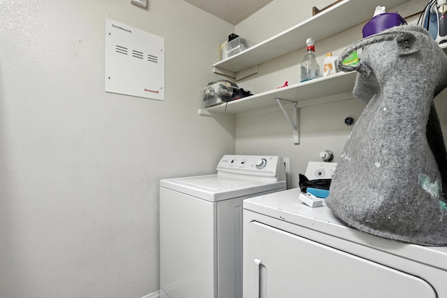 1230 Carrizo St NW, Los Lunas, NM 87031 - washroom featuring separate washer and dryer and baseboards