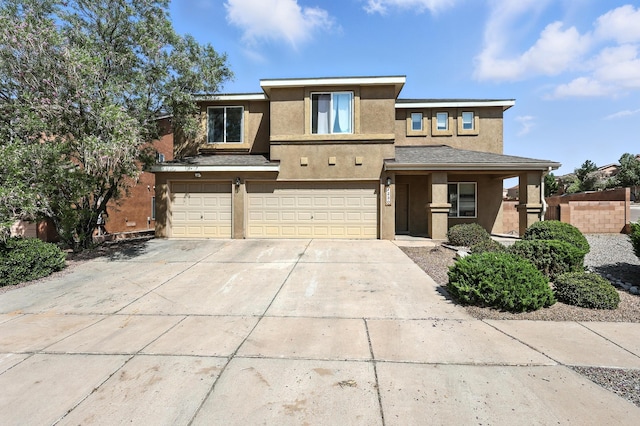 1230 Carrizo St NW, Los Lunas, NM 87031 - prairie-style home with stucco siding, an attached garage, and concrete driveway