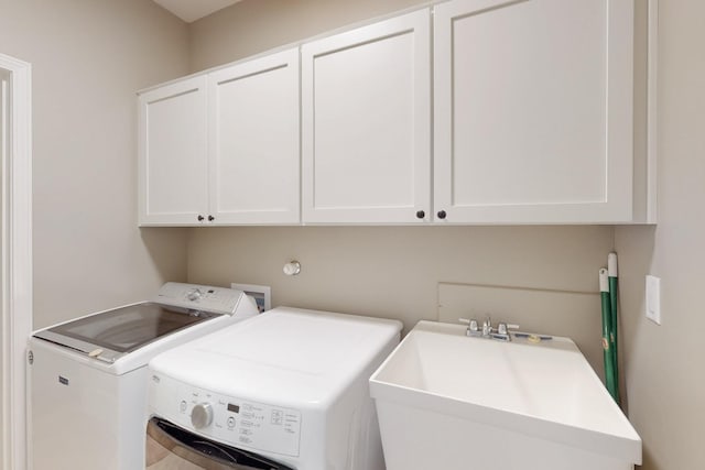 4813 Guadalupe Peak St SW, Los Lunas, NM 87031 - laundry area featuring cabinet space and washing machine and clothes dryer