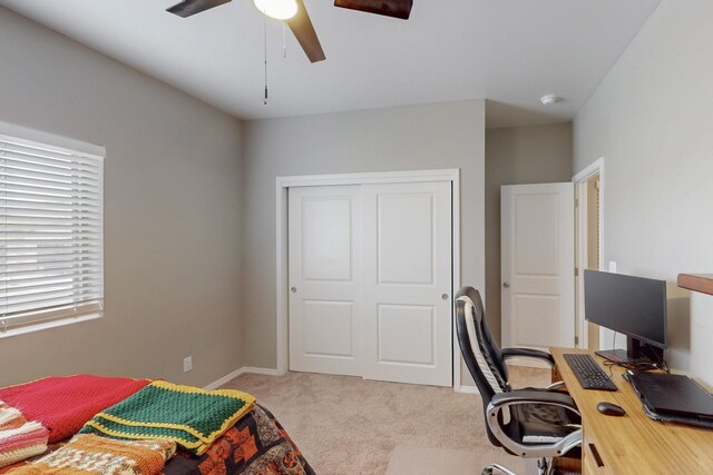 4813 Guadalupe Peak St SW, Los Lunas, NM 87031 - bedroom featuring light colored carpet, a desk, a closet, and a ceiling fan