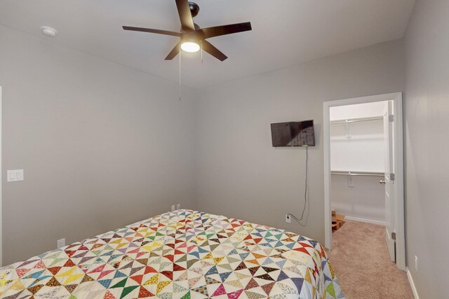 4813 Guadalupe Peak St SW, Los Lunas, NM 87031 - carpeted bedroom with a walk in closet, ceiling fan, and a closet