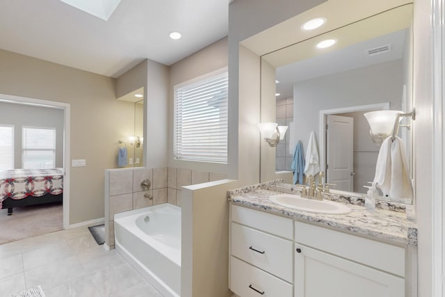 4813 Guadalupe Peak St SW, Los Lunas, NM 87031 - ensuite bathroom featuring vanity, a bath, plenty of natural light, tile patterned floors, and recessed lighting