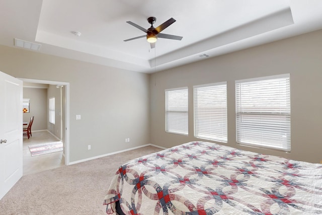 4813 Guadalupe Peak St SW, Los Lunas, NM 87031 - bedroom with a raised ceiling, light colored carpet, and a ceiling fan