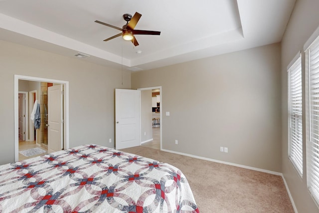 4813 Guadalupe Peak St SW, Los Lunas, NM 87031 - bedroom featuring light carpet, a tray ceiling, and ceiling fan