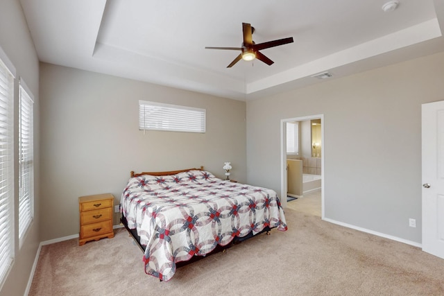 4813 Guadalupe Peak St SW, Los Lunas, NM 87031 - bedroom with a tray ceiling, light colored carpet, multiple windows, and ensuite bathroom