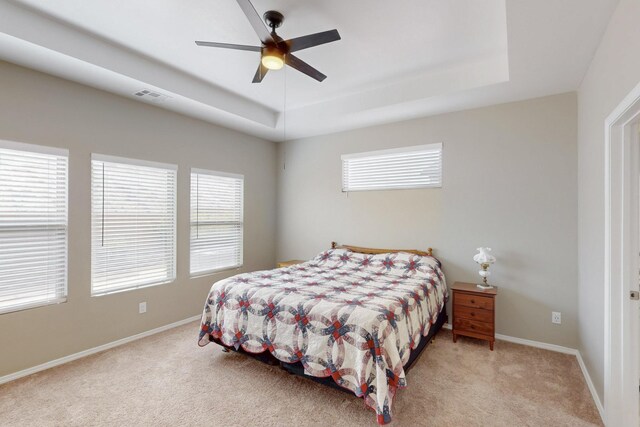 4813 Guadalupe Peak St SW, Los Lunas, NM 87031 - bedroom featuring a raised ceiling, carpet floors, and multiple windows