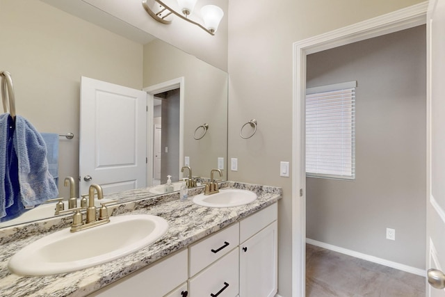 4813 Guadalupe Peak St SW, Los Lunas, NM 87031 - bathroom featuring double vanity and baseboards