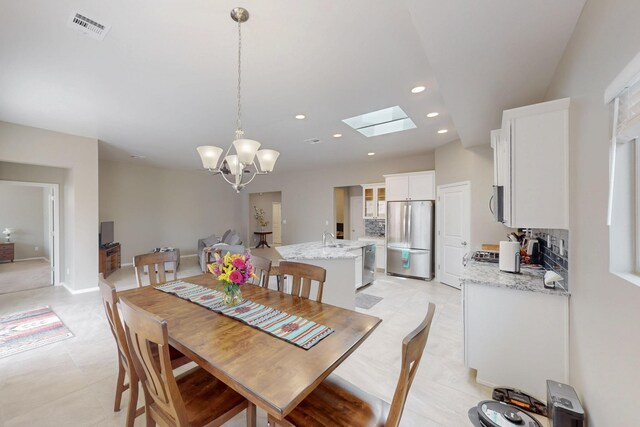 4813 Guadalupe Peak St SW, Los Lunas, NM 87031 - dining room with a chandelier, recessed lighting, and a skylight