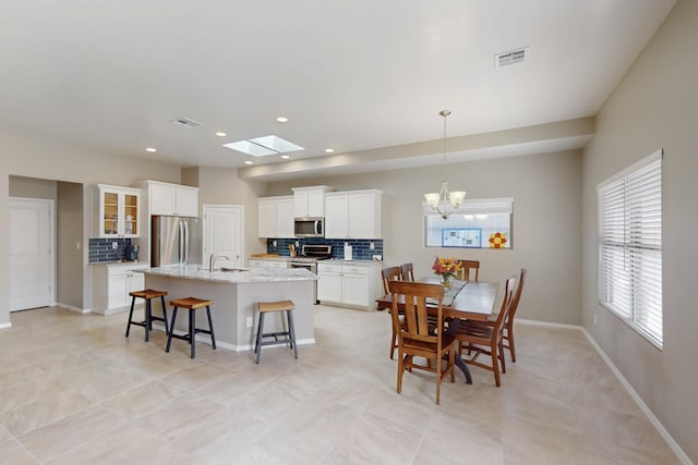 4813 Guadalupe Peak St SW, Los Lunas, NM 87031 - dining room with a chandelier, recessed lighting, and a skylight
