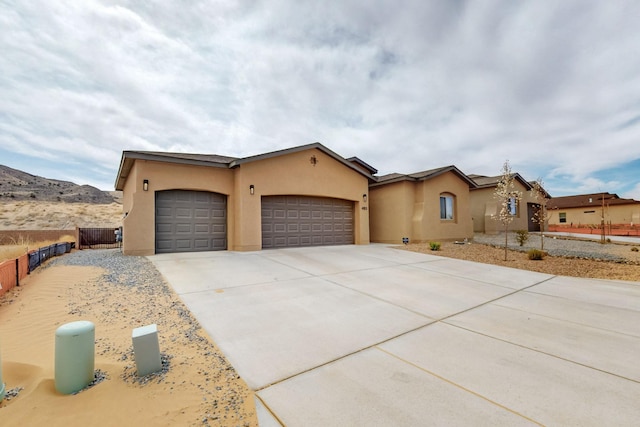 4813 Guadalupe Peak St SW, Los Lunas, NM 87031 - view of front of property featuring a garage, stucco siding, and concrete driveway
