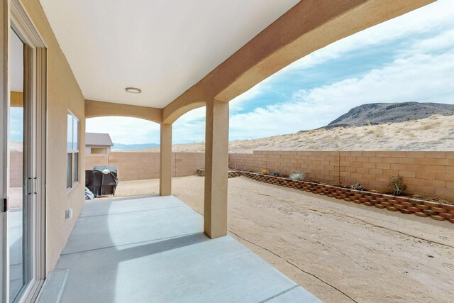 4813 Guadalupe Peak St SW, Los Lunas, NM 87031 - fenced backyard featuring a mountain view and a patio
