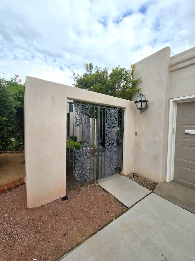 3244 La Ronda Pl NE, Albuquerque, NM 87110 - property entrance featuring a gate and stucco siding