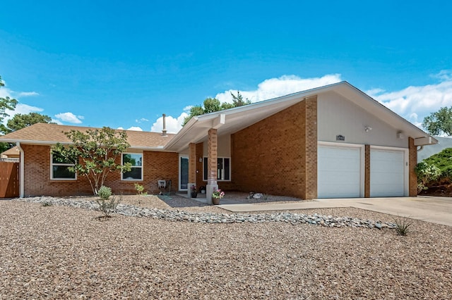 6940 Cherry Hills Loop NE, Albuquerque, NM 87111 - view of front of property featuring driveway, a garage, brick siding, and a shingled roof