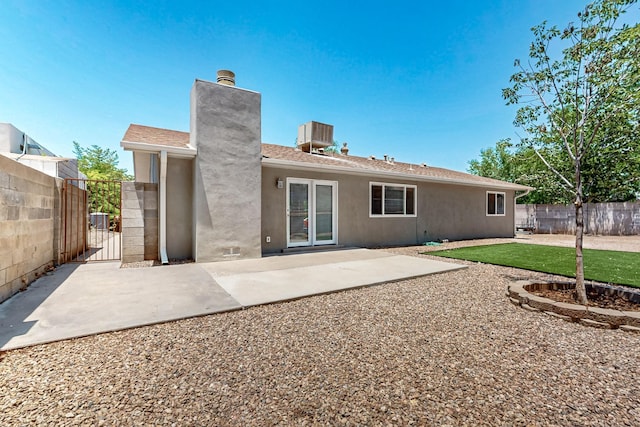 6940 Cherry Hills Loop NE, Albuquerque, NM 87111 - rear view of house featuring stucco siding, a chimney, a gate, and a patio area