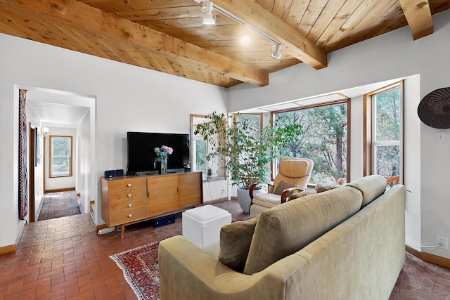 19 Villa Del Monte Loop, Tijeras, NM 87059 - living area with a wood ceiling with exposed beams, rail lighting, and brick flooring