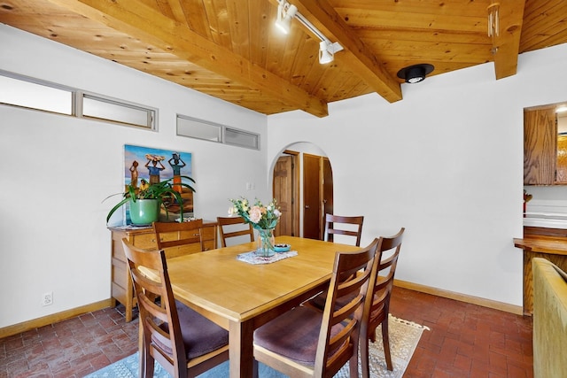 19 Villa Del Monte Loop, Tijeras, NM 87059 - dining area with arched walkways, brick floors, track lighting, and a wooden ceiling with exposed beams