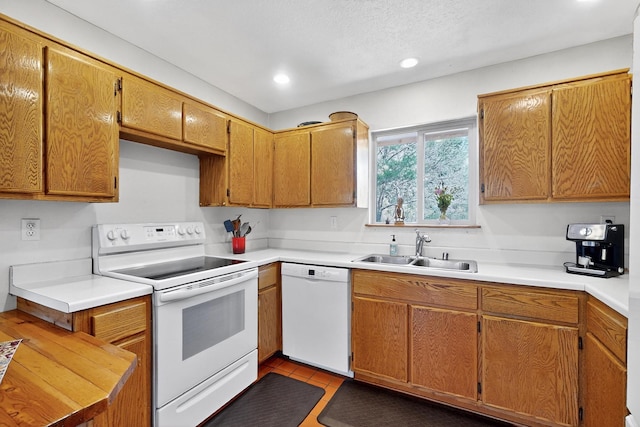 19 Villa Del Monte Loop, Tijeras, NM 87059 - kitchen featuring white appliances, recessed lighting, light countertops, and brown cabinets