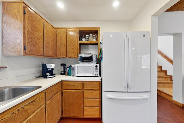 19 Villa Del Monte Loop, Tijeras, NM 87059 - kitchen with white appliances, open shelves, light countertops, recessed lighting, and brown cabinetry