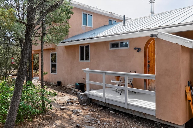 19 Villa Del Monte Loop, Tijeras, NM 87059 - back of house with a standing seam roof, a deck, a metal roof, and stucco siding