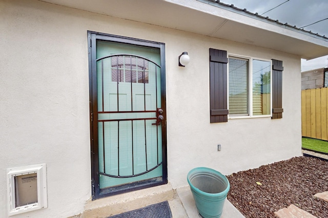 1259 8th St NW, Albuquerque, NM 87102 - doorway to property with stucco siding