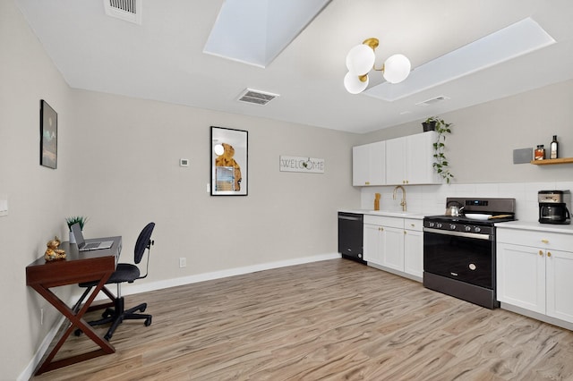 1259 8th St NW, Albuquerque, NM 87102 - kitchen with stainless steel range, dishwasher, a skylight, light wood-style floors, and backsplash