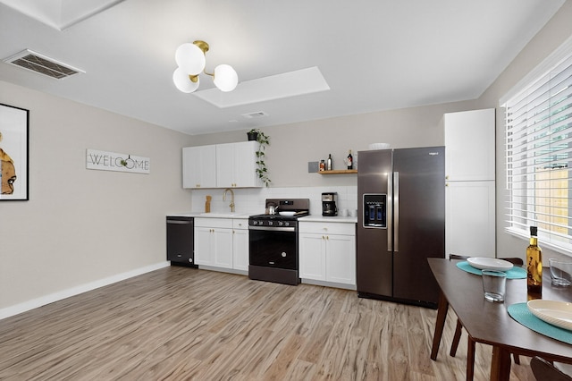 1259 8th St NW, Albuquerque, NM 87102 - kitchen with appliances with stainless steel finishes, light wood-type flooring, light countertops, white cabinetry, and decorative backsplash