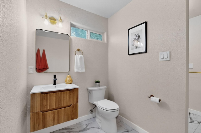 1259 8th St NW, Albuquerque, NM 87102 - bathroom with marble look tiles, vanity, and a textured wall