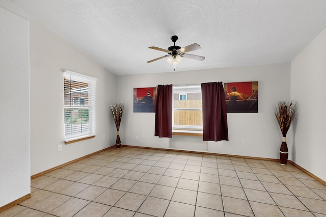 1259 8th St NW, Albuquerque, NM 87102 - unfurnished room featuring healthy amount of natural light, a ceiling fan, a textured ceiling, and light tile patterned flooring