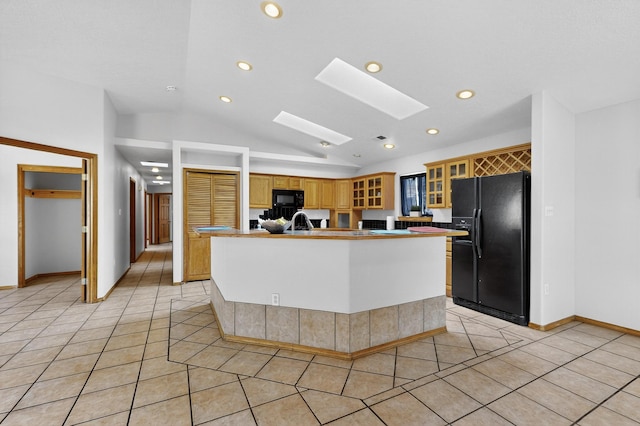 1259 8th St NW, Albuquerque, NM 87102 - kitchen featuring black appliances, light tile patterned flooring, lofted ceiling, recessed lighting, and a skylight