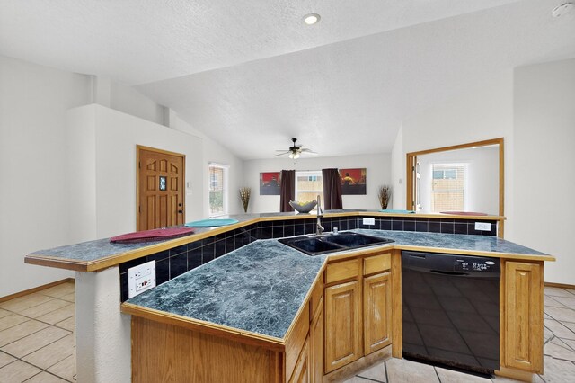 1259 8th St NW, Albuquerque, NM 87102 - kitchen with black dishwasher, light tile patterned floors, a ceiling fan, lofted ceiling, and an island with sink