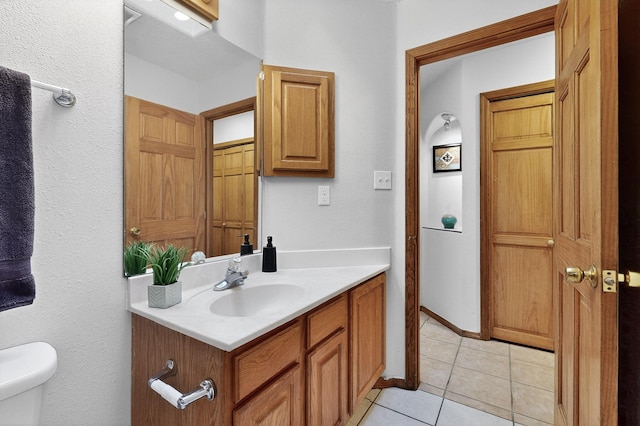 1259 8th St NW, Albuquerque, NM 87102 - bathroom featuring vanity, tile patterned floors, and a textured wall