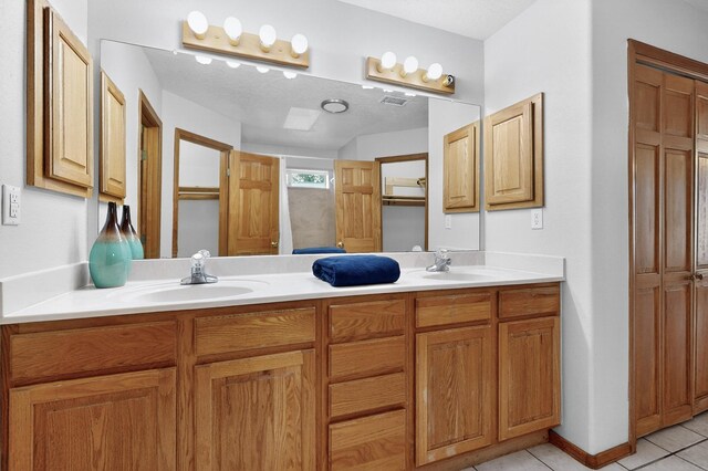 1259 8th St NW, Albuquerque, NM 87102 - full bathroom with tile patterned floors and double vanity