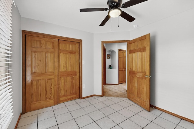 1259 8th St NW, Albuquerque, NM 87102 - unfurnished bedroom with light tile patterned floors and ceiling fan