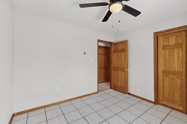 1259 8th St NW, Albuquerque, NM 87102 - unfurnished bedroom with light tile patterned floors and ceiling fan