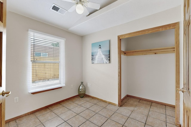1259 8th St NW, Albuquerque, NM 87102 - unfurnished bedroom with a closet, light tile patterned flooring, and a ceiling fan