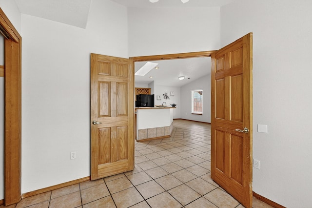 1259 8th St NW, Albuquerque, NM 87102 - unfurnished room with vaulted ceiling and light tile patterned floors