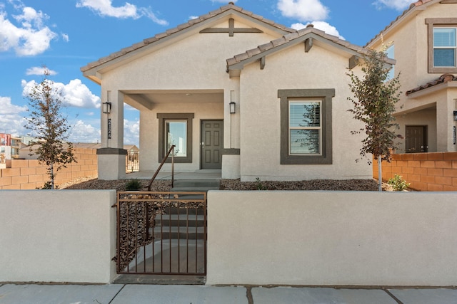5627 Sagan Loop SE, Albuquerque, NM 87106 - view of front of house featuring a fenced front yard, stucco siding, and a gate