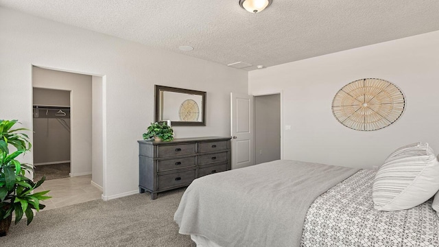 5627 Sagan Loop SE, Albuquerque, NM 87106 - bedroom with a spacious closet, a textured ceiling, and light colored carpet