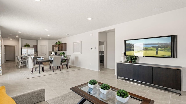 5627 Sagan Loop SE, Albuquerque, NM 87106 - living room with light tile patterned floors, a textured ceiling, and recessed lighting