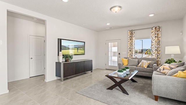 5627 Sagan Loop SE, Albuquerque, NM 87106 - living area featuring a textured ceiling, light tile patterned floors, and recessed lighting