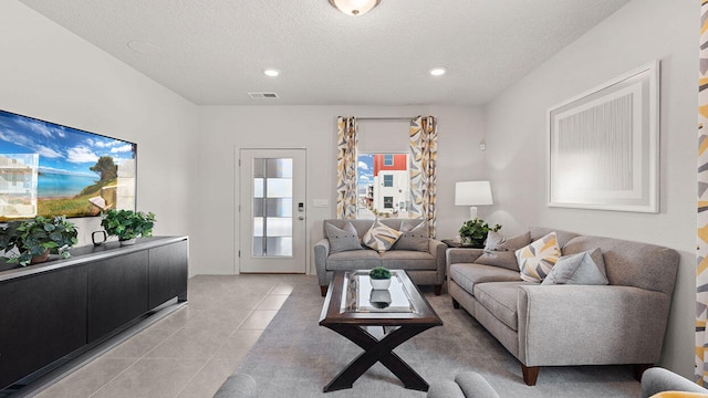 5627 Sagan Loop SE, Albuquerque, NM 87106 - living area with light tile patterned floors, a textured ceiling, and recessed lighting