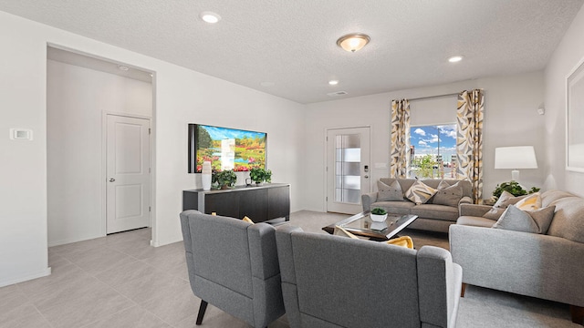 5627 Sagan Loop SE, Albuquerque, NM 87106 - living room featuring a textured ceiling, recessed lighting, and light tile patterned floors