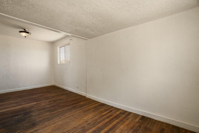 1601 7th St, Moriarty, NM 87035 - empty room with dark wood-type flooring and a textured ceiling