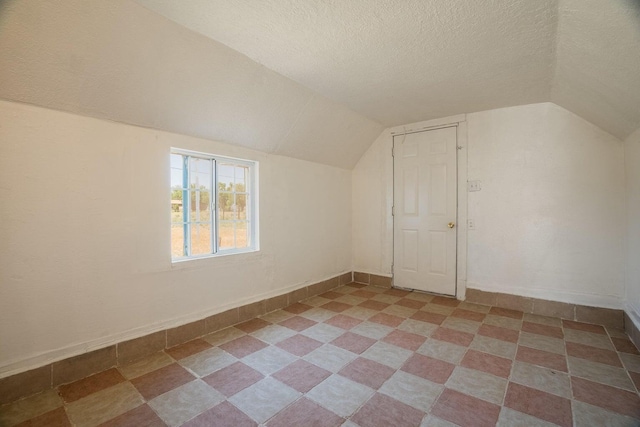 1601 7th St, Moriarty, NM 87035 - additional living space with lofted ceiling and a textured ceiling