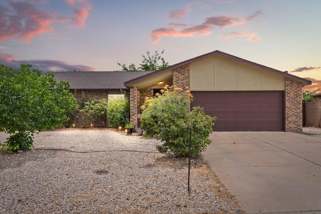 6404 Gambel Quail Rd NE, Rio Rancho, NM 87144 - view of front of home featuring brick siding, driveway, and an attached garage