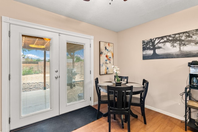6404 Gambel Quail Rd NE, Rio Rancho, NM 87144 - dining space featuring french doors, light wood-style flooring, a ceiling fan, and a textured ceiling