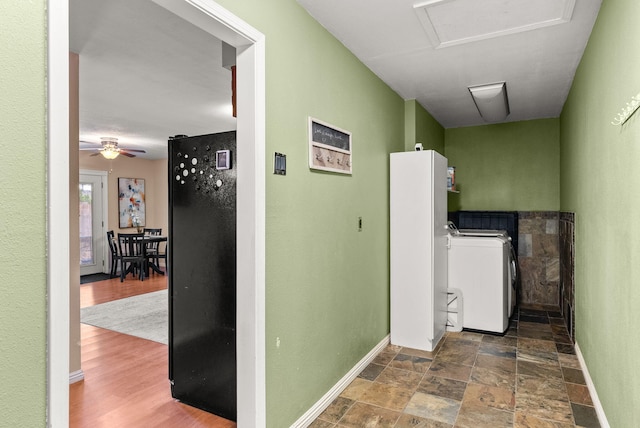 6404 Gambel Quail Rd NE, Rio Rancho, NM 87144 - corridor featuring attic access, washer and clothes dryer, and stone finish floors